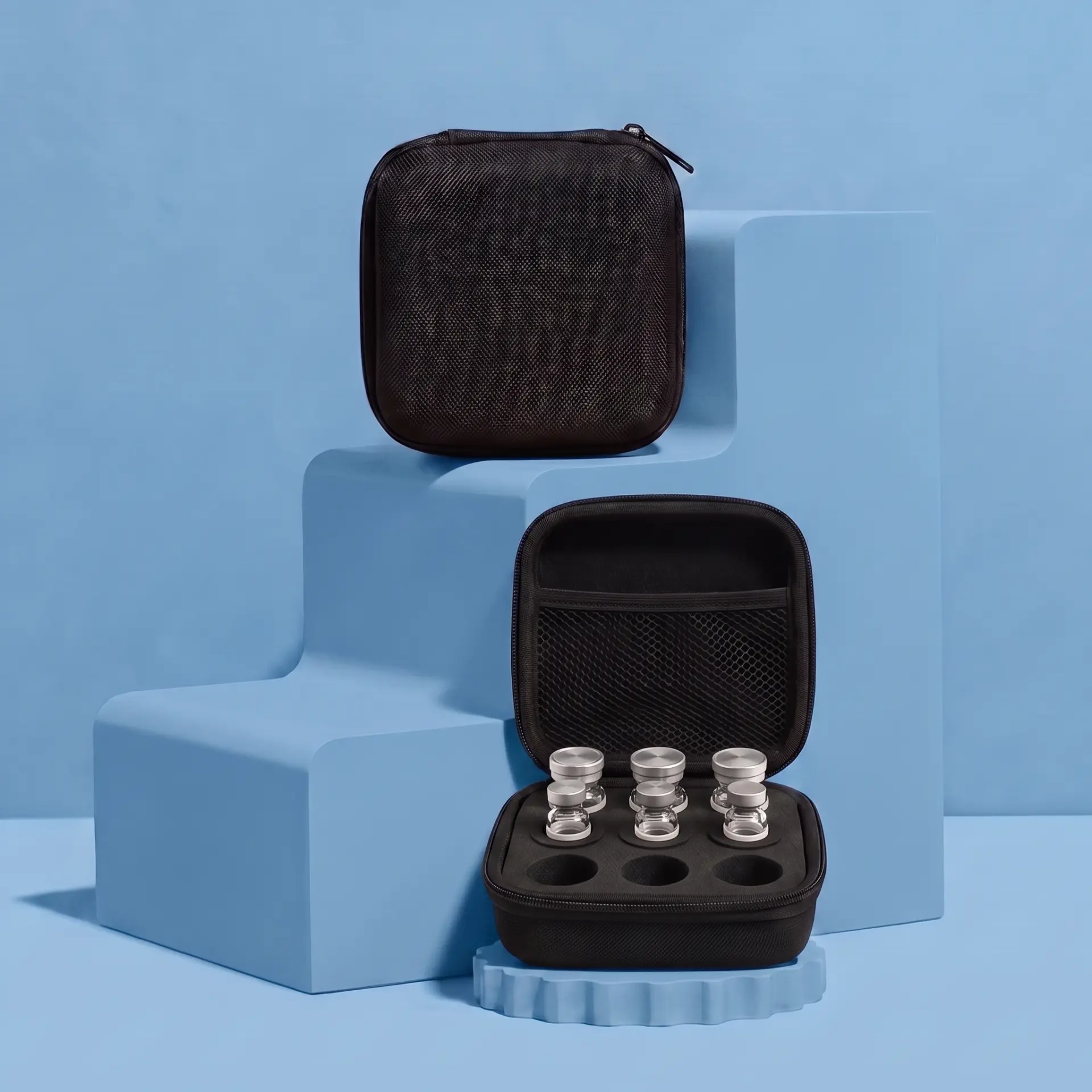Two black vial cases, one closed and one open with vials